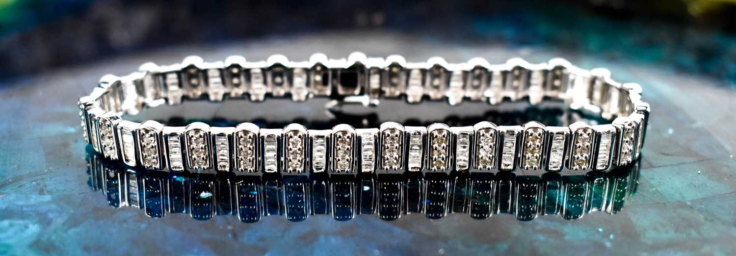 A 9ct white gold and diamond tennis bracelet, composed of links set with baguette cut and