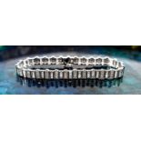A 9ct white gold and diamond tennis bracelet, composed of links set with baguette cut and