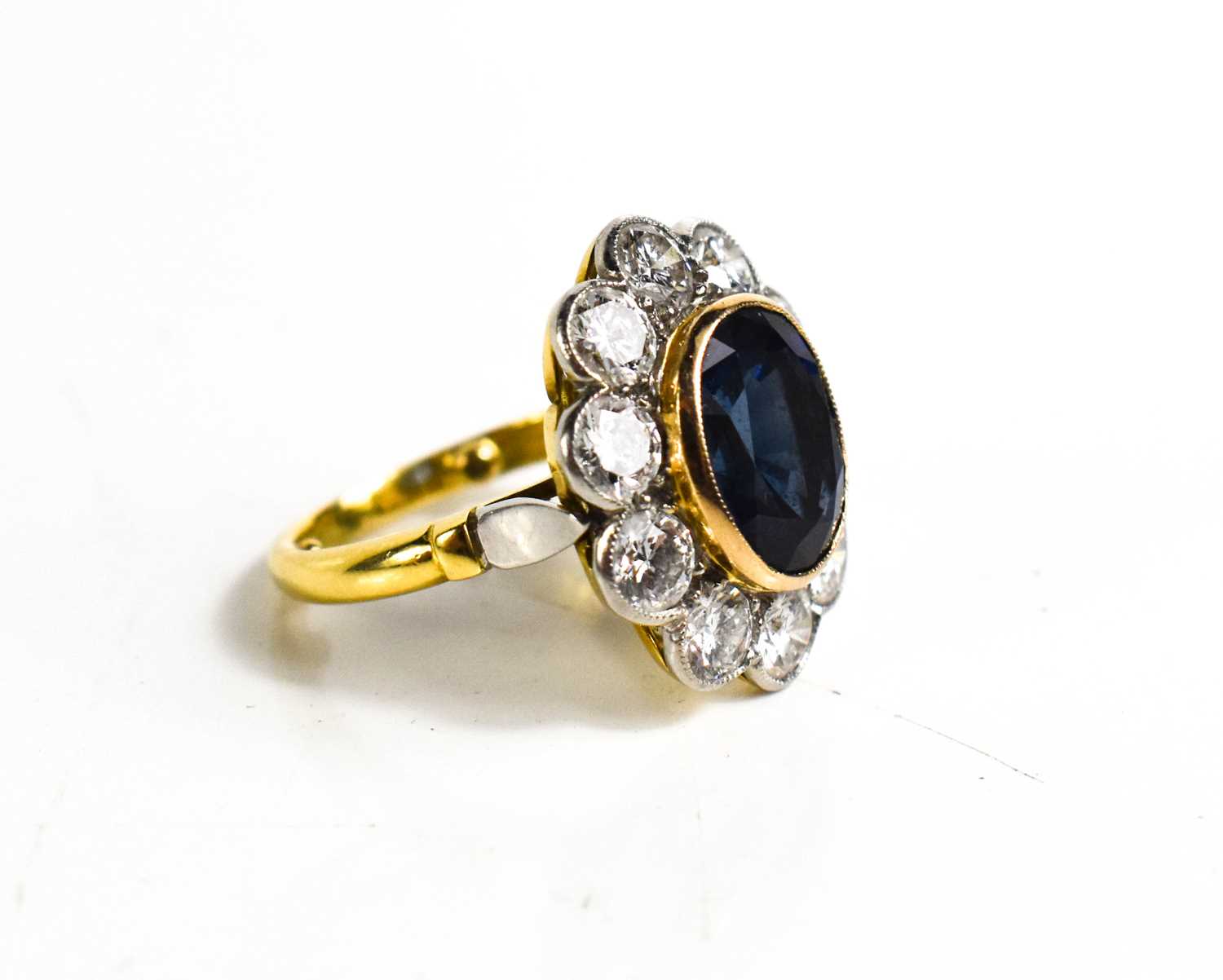An 18ct yellow gold, sapphire and diamond ring, the central oval cut deep cornflower blue sapphire - Image 3 of 10