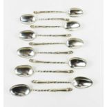 A group of ten white metal, possibly Dutch silver coffee spoons, the twist handles, the finials
