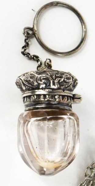 A Victorian acorn form vinaigrette, circa 1890, with clear glass bottle, white metal cover, and