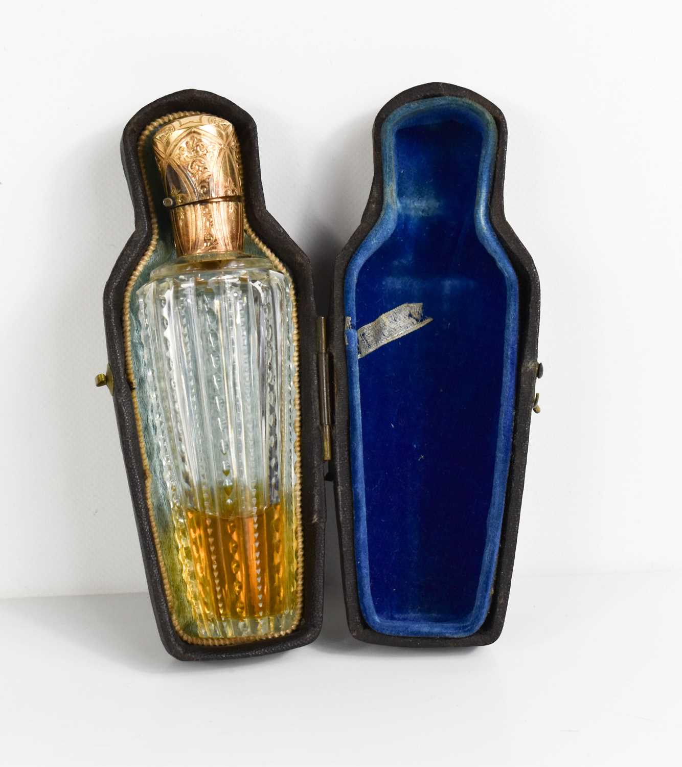 A 19th century scent bottle with cut glass body and stopper, with gold hinged lid (unmarked), in the