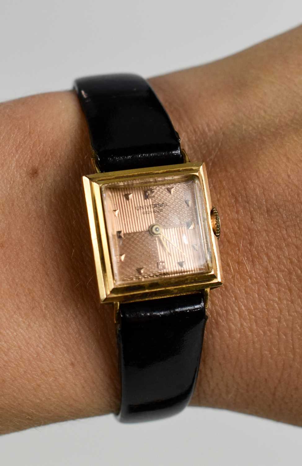 An 18ct Universal gold cased lady's watch, with engine turned rose gold coloured dial, with black