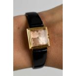 An 18ct Universal gold cased lady's watch, with engine turned rose gold coloured dial, with black