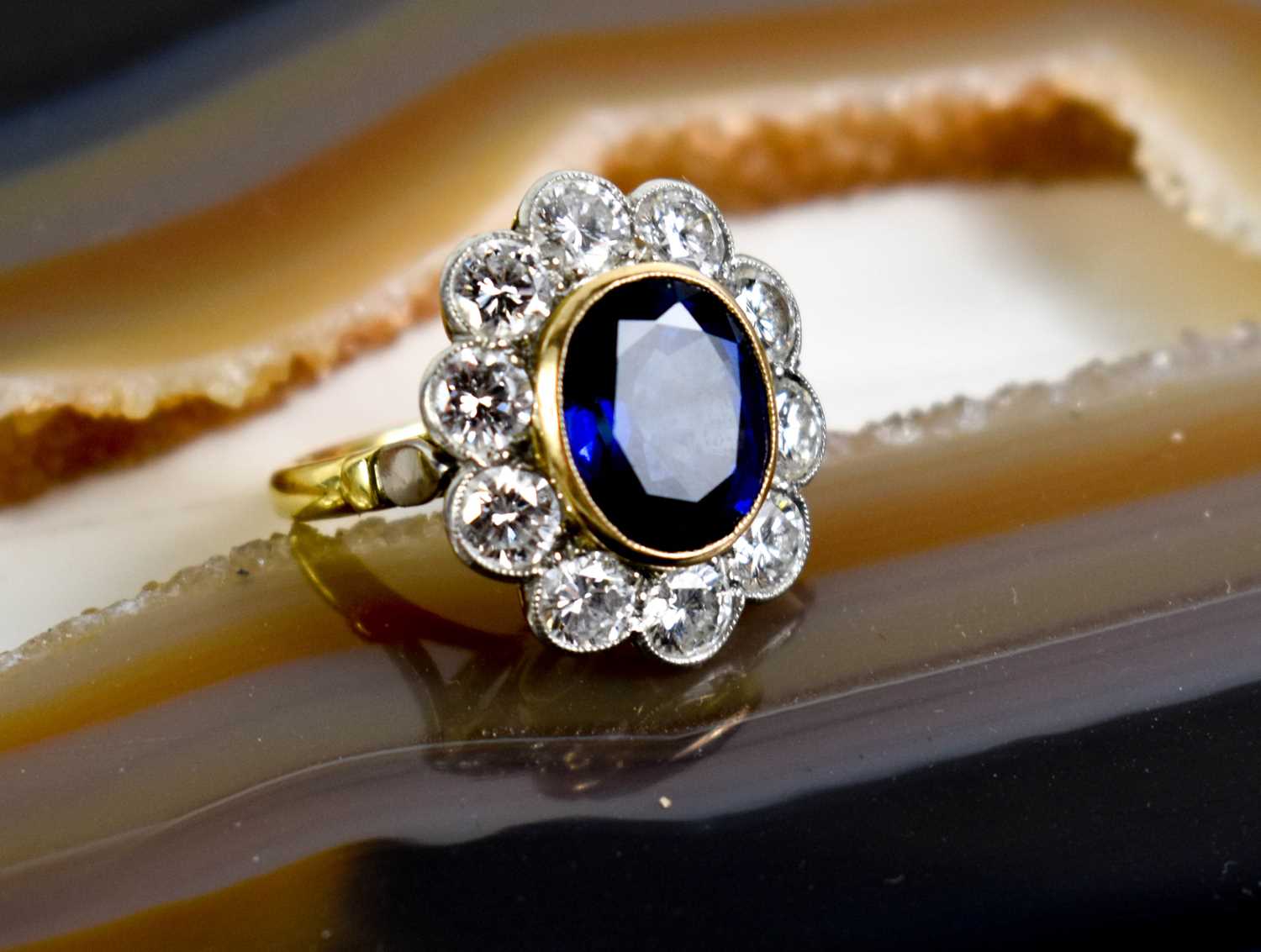 An 18ct yellow gold, sapphire and diamond ring, the central oval cut deep cornflower blue sapphire - Image 8 of 10
