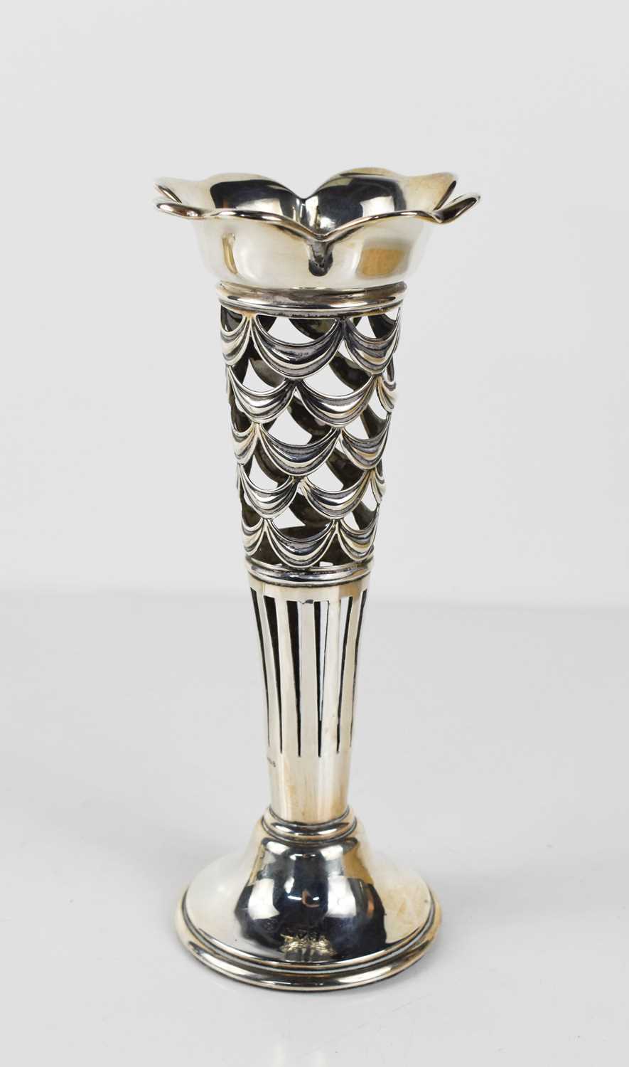An Edwardian silver trumpet form vase with pierced sides, hallmarked for Chester, 18cm tall, 5.