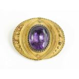 A Victorian amethyst pinchbeck mourning brooch, the delicate bead and rope setting set with an