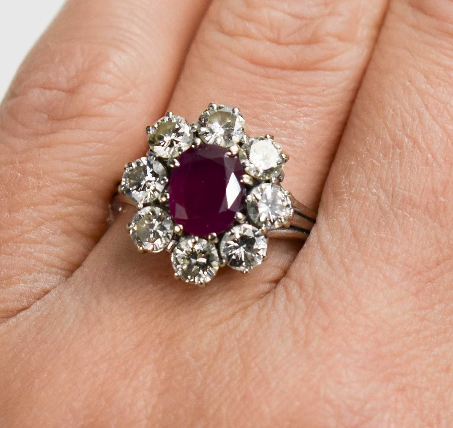 An 18ct white gold, (unmarked but tested as 18ct) ruby and diamond flowerhead ring, the central oval - Image 4 of 11