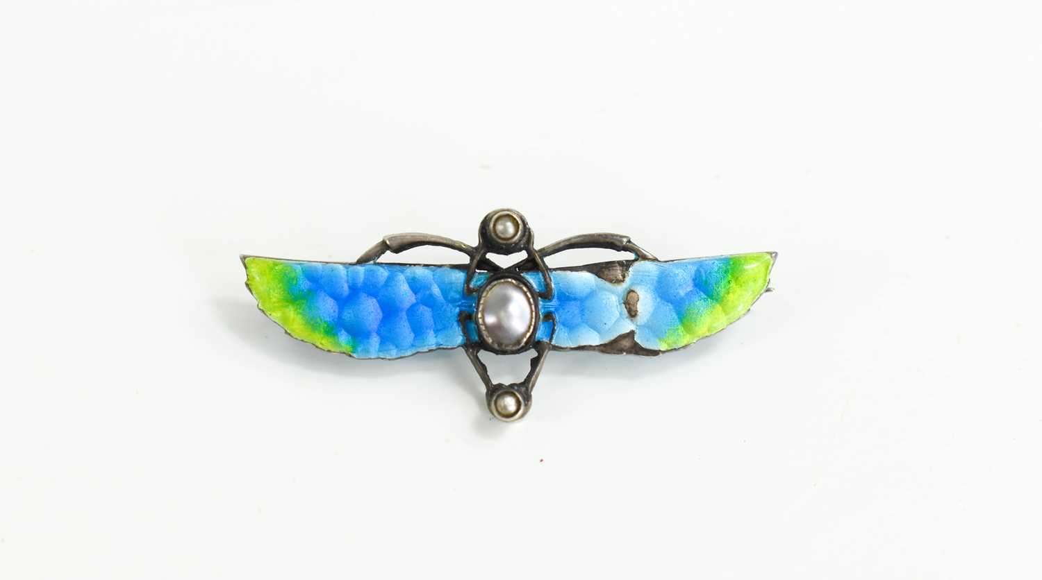 An Art Nouveau Egyptian Revival enamel, split seed pearl and blister pearl winged scarab brooch in