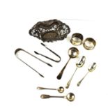 A group of silver comprising a small basket or bon bon dish, two napkin rings, two teaspoons, two