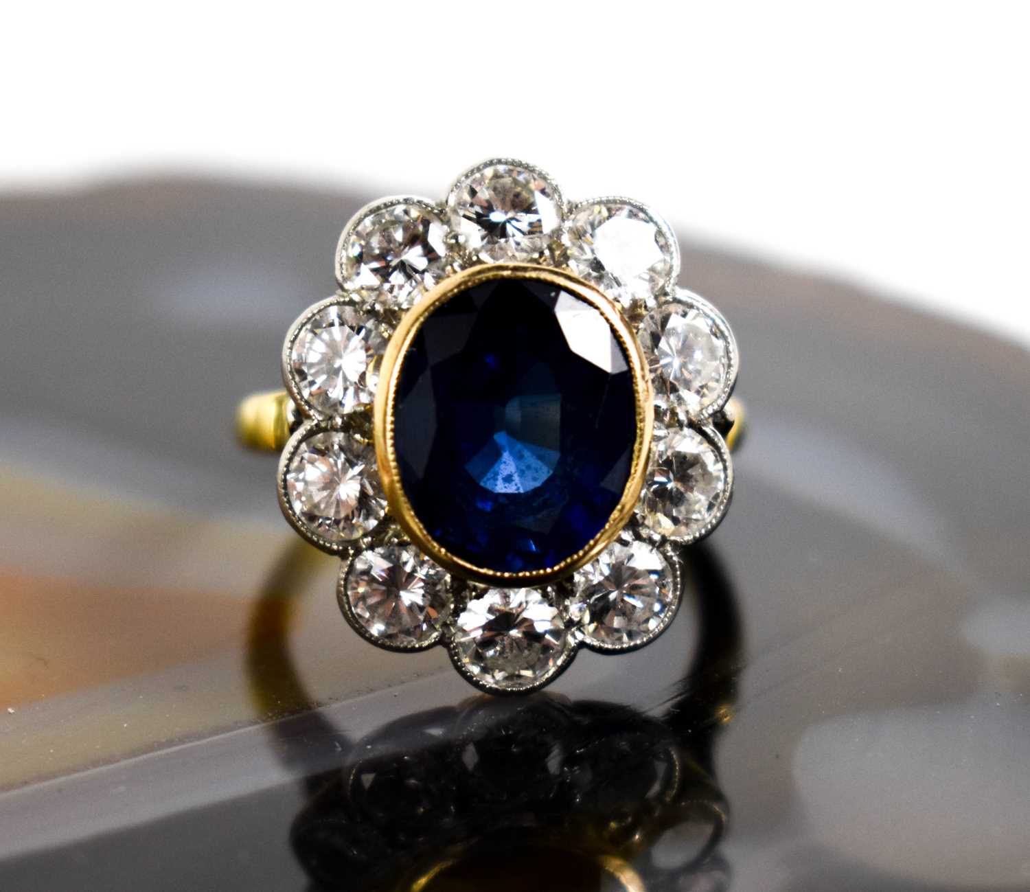 An 18ct yellow gold, sapphire and diamond ring, the central oval cut deep cornflower blue sapphire - Image 2 of 10