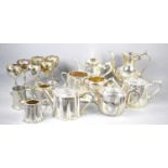 A group of silver plated items to include tea and coffee pots, goblets, sugar bowls and other