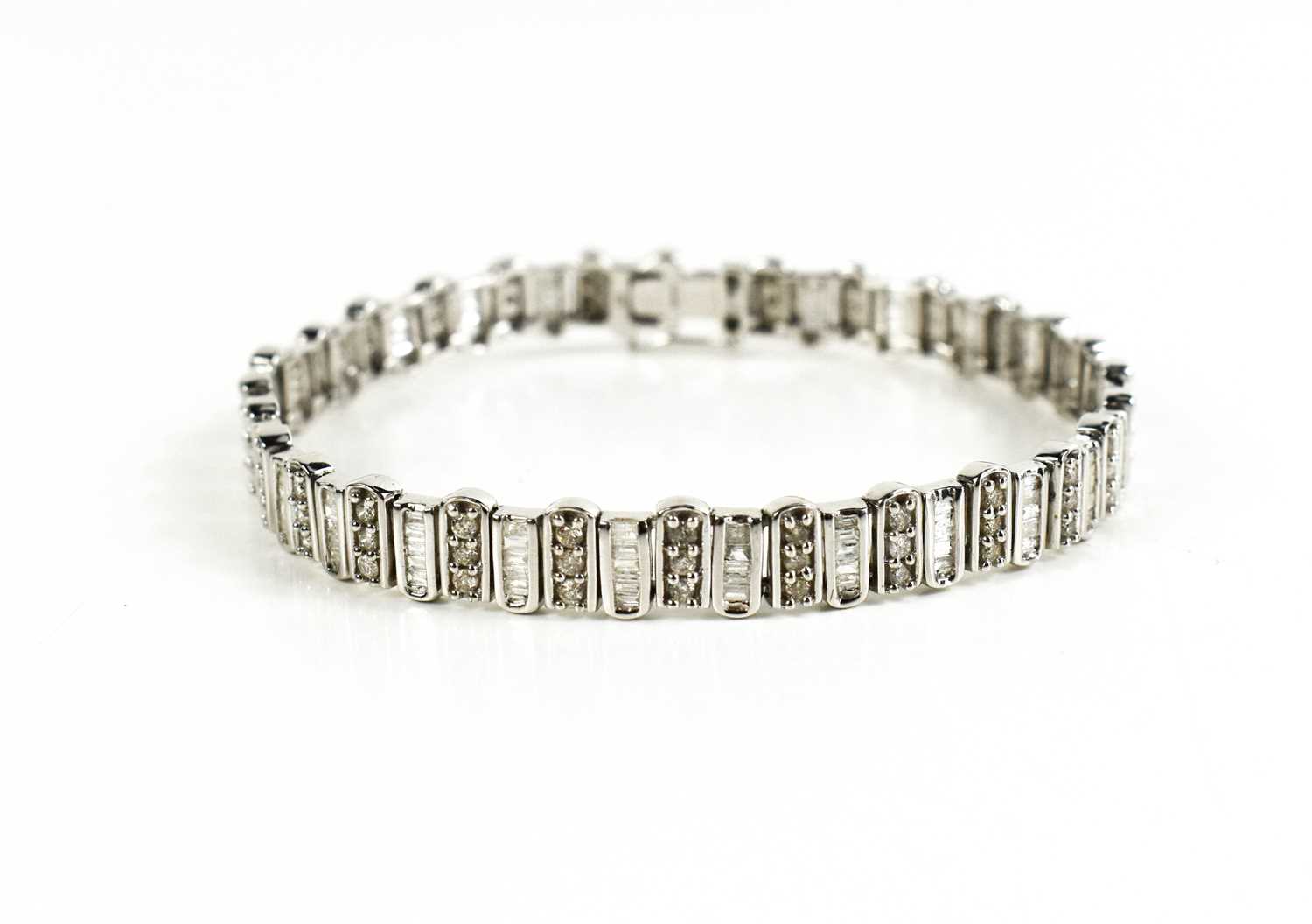 A 9ct white gold and diamond tennis bracelet, composed of links set with baguette cut and - Image 2 of 6