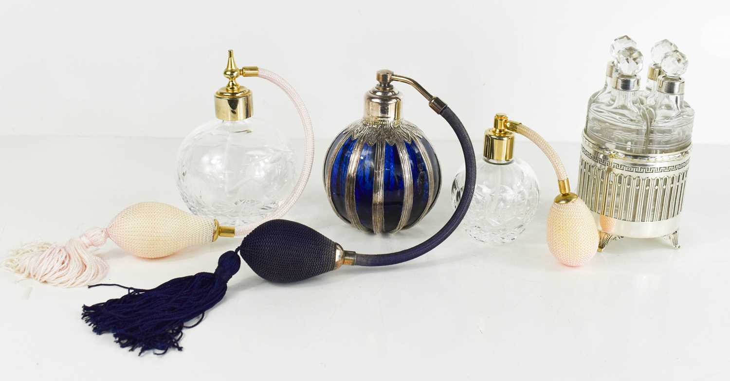 Three glass vintage atomisers, one in blue glass clad in silver (tested as), together with a rare