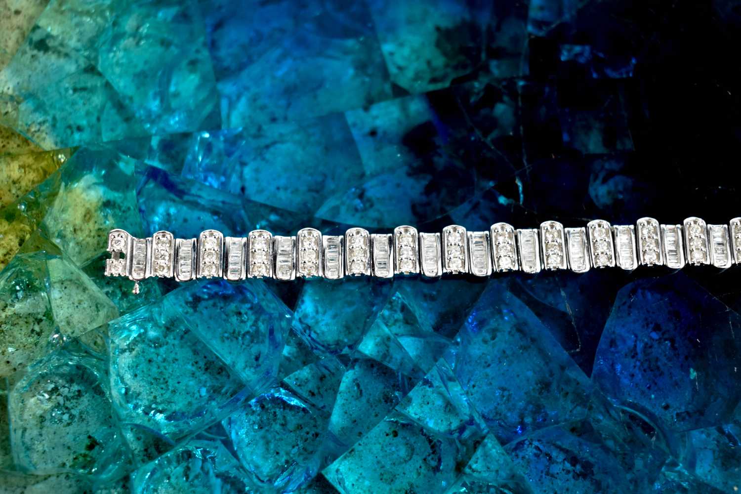 A 9ct white gold and diamond tennis bracelet, composed of links set with baguette cut and - Image 6 of 6