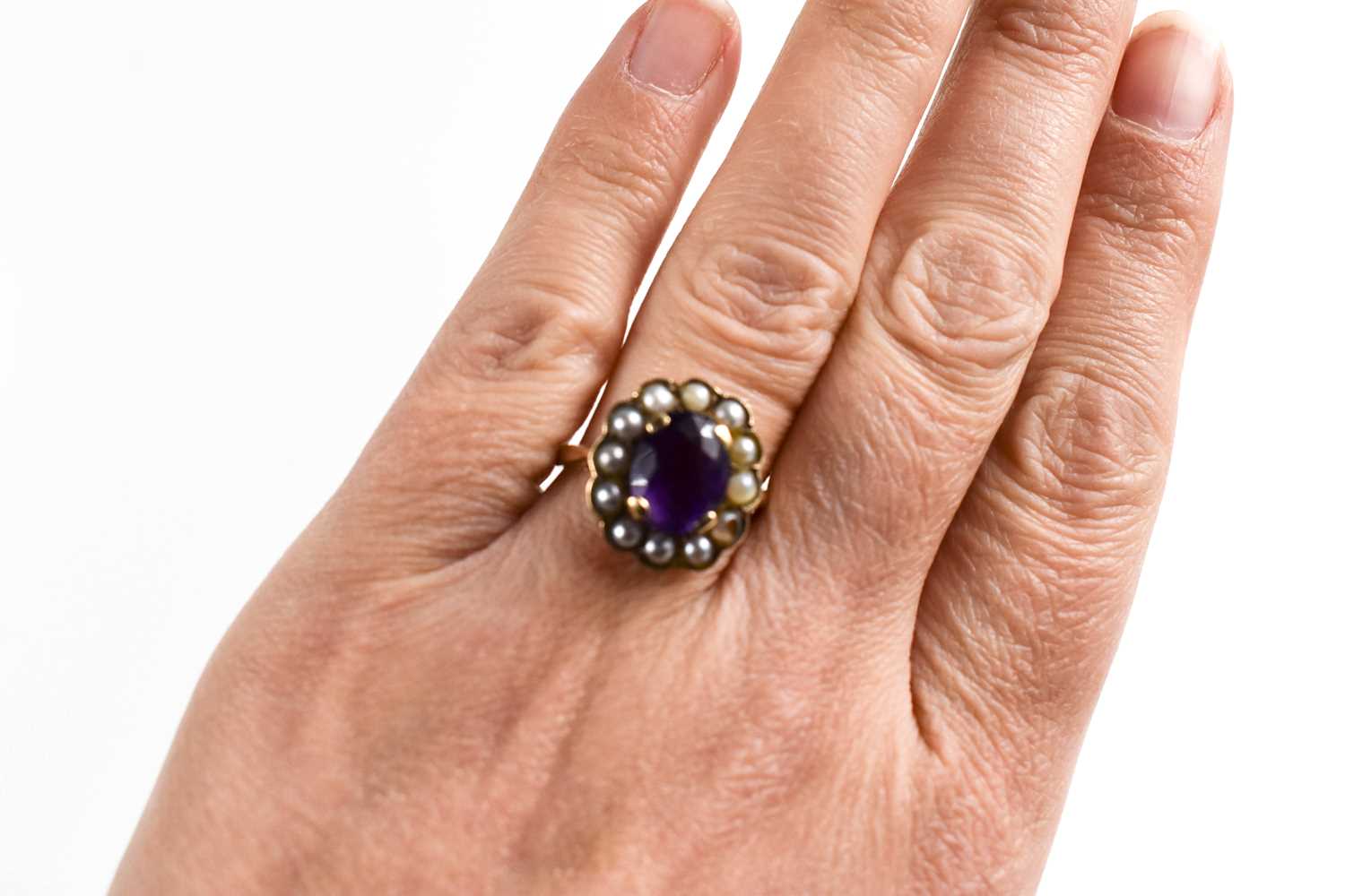 A 9ct gold, amethyst and seed pearl ring, the oval cut amethyst 10mm by 7mm, bordered by seed - Image 3 of 6