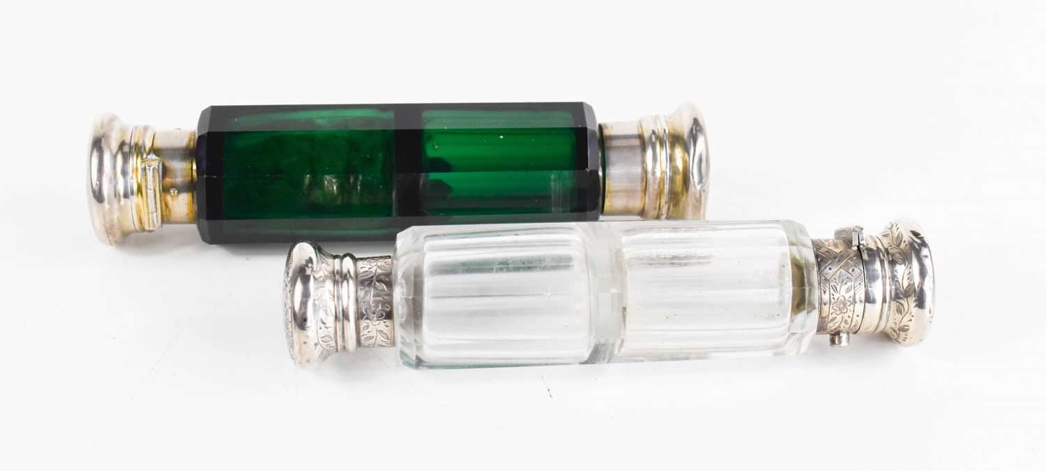 Two Victorian double ended scent bottles, one in green glass, one clear, and both of faceted form.