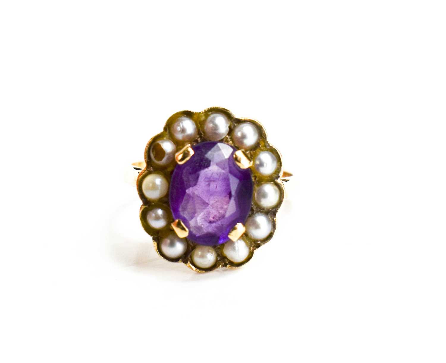 A 9ct gold, amethyst and seed pearl ring, the oval cut amethyst 10mm by 7mm, bordered by seed - Image 2 of 6