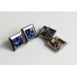 A pair of white metal and sapphire cufflinks, of square form, each set with four emerald cut