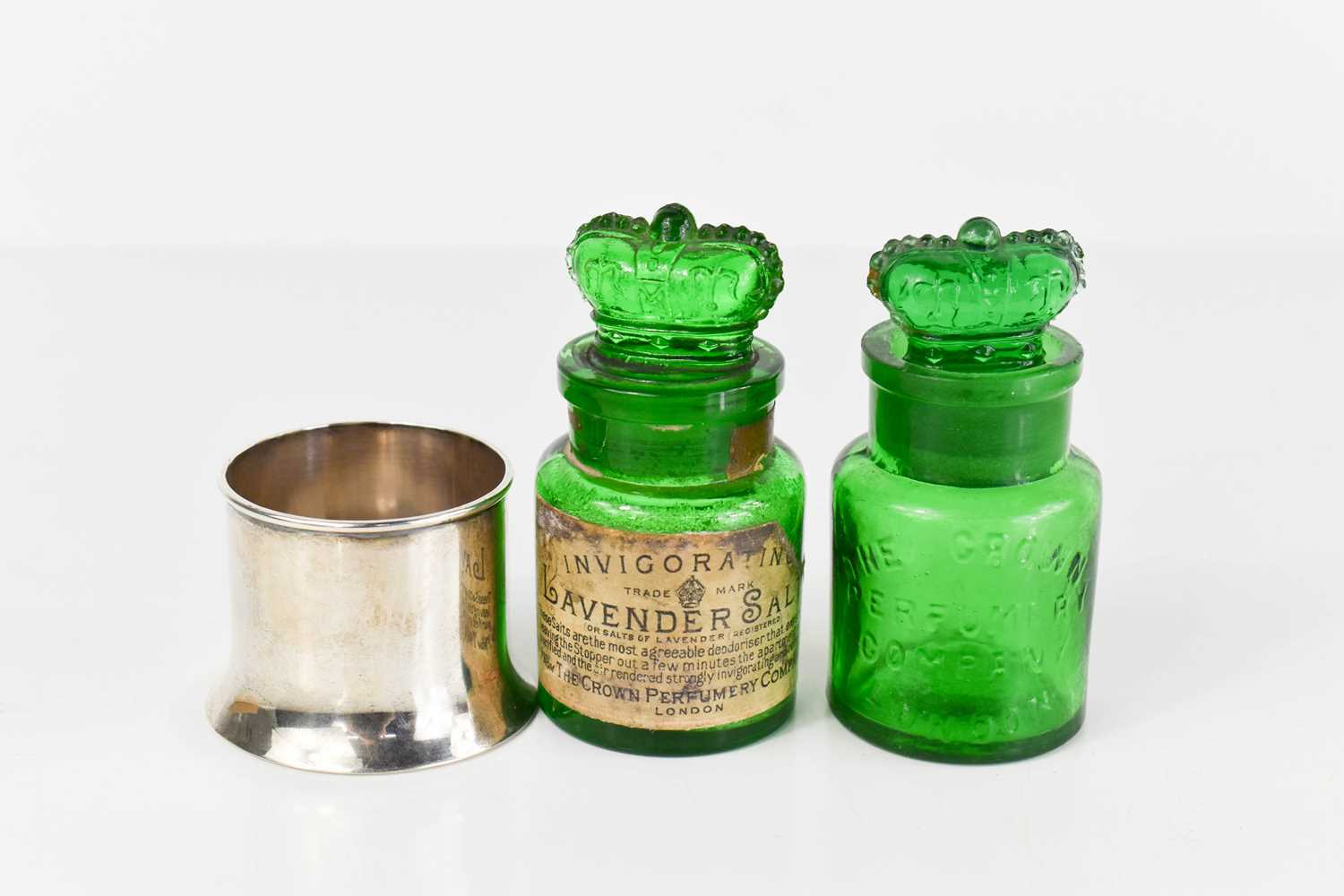 Two Crown Perfumery Company of London green glass bottles, one in silver case by Deakin Francis,