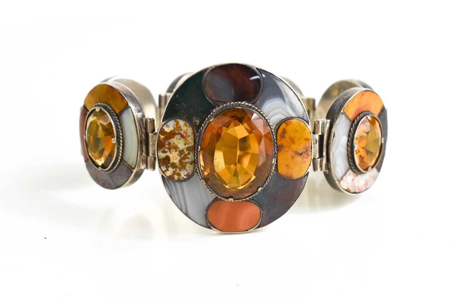 A Scottish silver, agate and orange Cairngorm stone set bracelet, composed of seven oval links, each