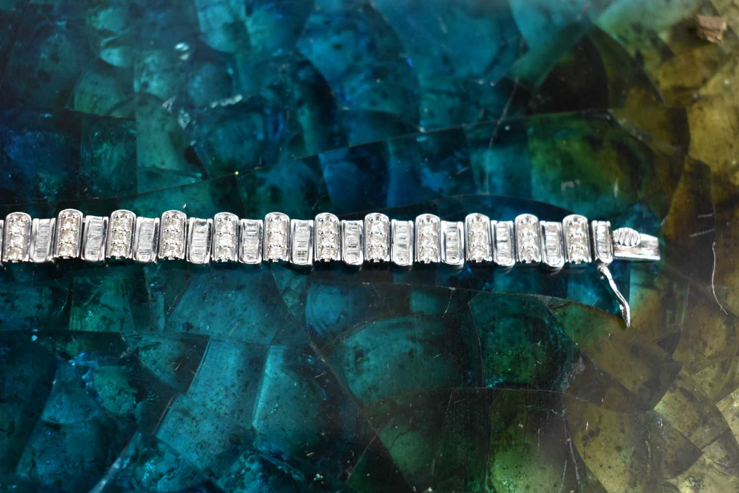 A 9ct white gold and diamond tennis bracelet, composed of links set with baguette cut and - Image 5 of 6