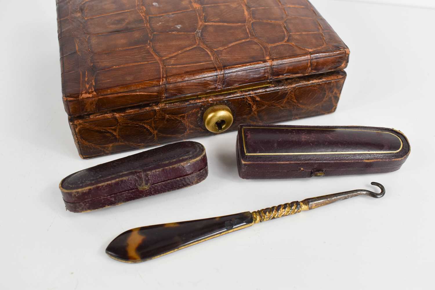 An early 20th century crocodile skin jewellery box together with two amber cheroot holders, one with - Image 2 of 2