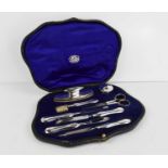 A cased silver manicure set, by Goldsmiths & Silversmiths London, Birmingham 1923, in the original