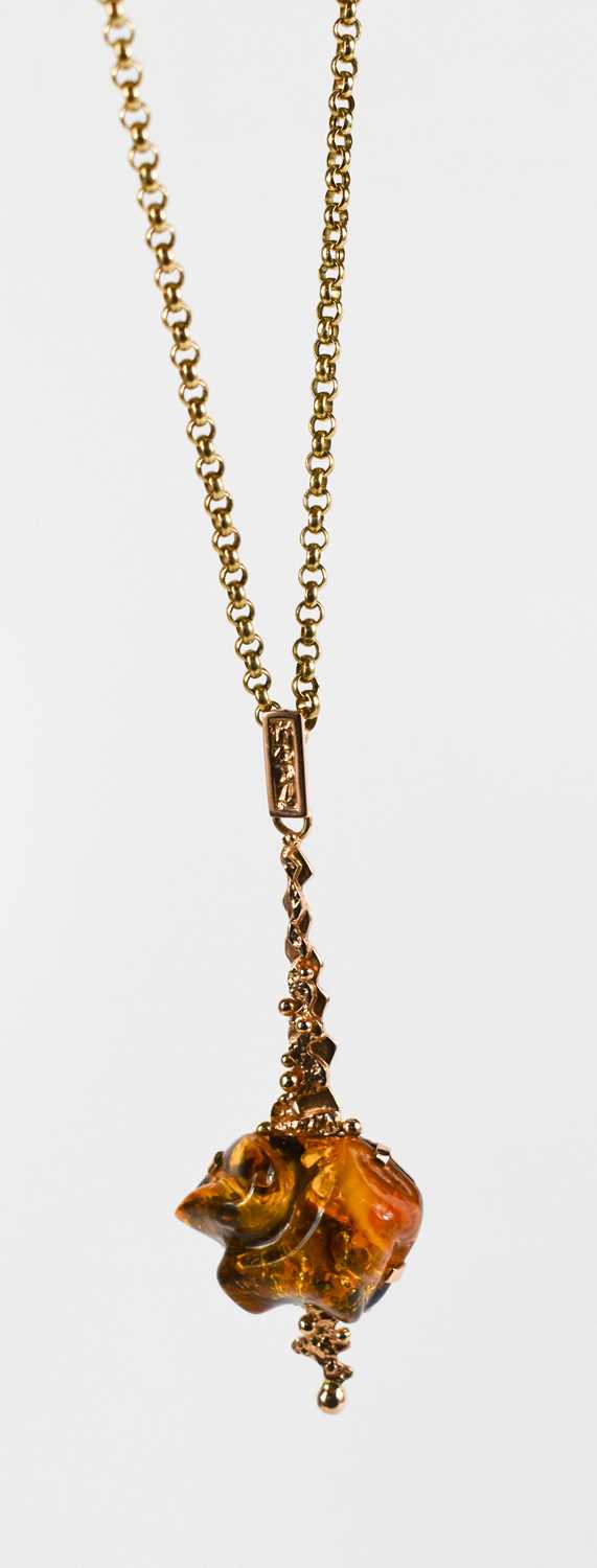 A 14ct rose gold and amber pendant, of contemporary design, on a 9ct gold chain link necklace, 7. - Image 2 of 4