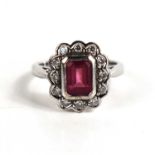 An 18ct with gold, pink tourmaline and diamond dress ring, the central emerald cut tourmaline of