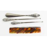 A sterling silver and faux tortoiseshell comb, two silver handled button hooks; Birmingham 1903