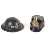 A WWII police helmet, together with a further vintage leather police helmet, the badge insignia with