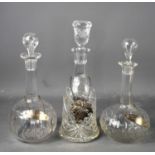 A pair of cut glass antique decanters with matching silver bottle tags labelled port and brandy,