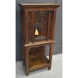 A 16th century style Gothic oak cupboard, the single door having decorative iron lock plate and