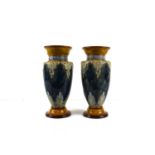 A pair of Doulton Lambeth vases, with mottled blue ground embossed with anthemion motifs, signed