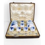 A fine Royal Worcester set of coffee cans and saucers, painted with blue grape and vine decoration