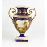 A Derby 19th century twin handled vase, painted with a Welsh view, with gilded scrollwork, cobalt
