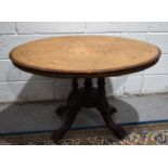 A Victorian oval top marquetry inlaid tea table raised on five columns, 72cm high.