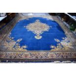 A large wool carpet, the cobalt blue ground with central with cobalt blue ground with central