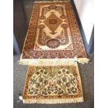 A North Indian rug, cream ground with red spandrels and arabesque with repeating geometric motifs to