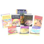 Seven Harry Potter novels by J.K Rowling, some first editions and first printings.