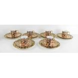 A set of six Royal Crown Derby coffee cans and saucers with matching side plates (six trios) in