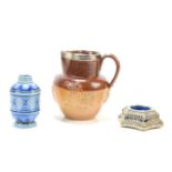 A Doulton Lambeth stoneware jug with silver rim together with a Doulton Lambeth salt pot and an