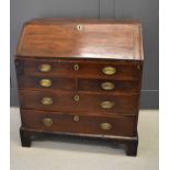 A 19th century mahogany bureau of small proportions, the full front enclosing a fitted interior,