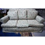 An early 20th century country house style three seater sofa, with tulip flower covers, the