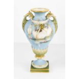 A Royal Worcester Charles Baldwin twin handled pedestal vase, circa 1920, painted to a blue
