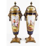 A pair of 19th century Vienna vases and covers, painted with panels of figures in landscapes, on