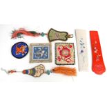 A collection of early 20th century Chinese silk needle cases, fan cases, pin cushion and a small