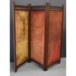 A Chinese mahogany three-fold screen having pierced panels above Chinese embroidered silk works (