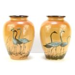 A pair of 19th century Doulton Lambeth vases circa 1892, by Florence Barlow, depicting cranes, and